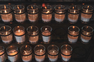 High angle view of burning candles in temple