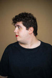Feminine overweight male with red lips representing concept of alternative masculinity and queer community