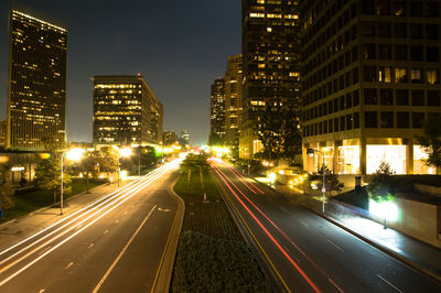 Light trails on road in city at night