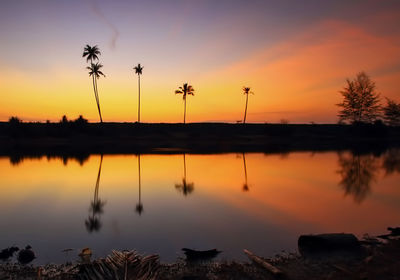 Scenic view of lake against orange sky