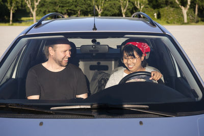 Man teaching woman to drive