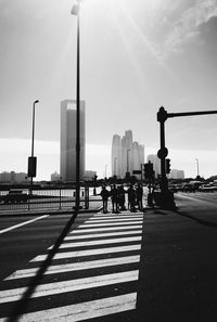 People crossing road against sky