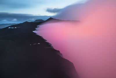 Scenic view of silhouette mountain against sky at sunset