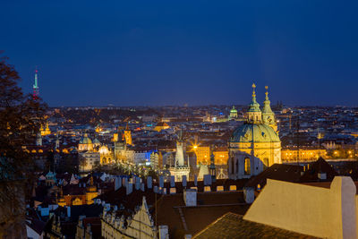 High angle view of illuminated city against blue sky