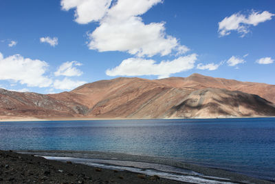 Scenic view of mountain against cloudy sky