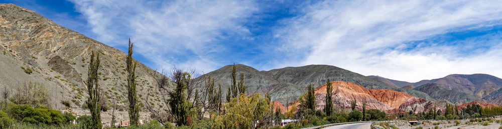 Panoramic view of mountains against blue sky