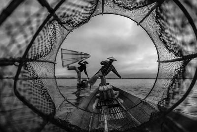 Close-up of fishing net against sky