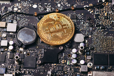 Close-up of bitcoin with computer equipment