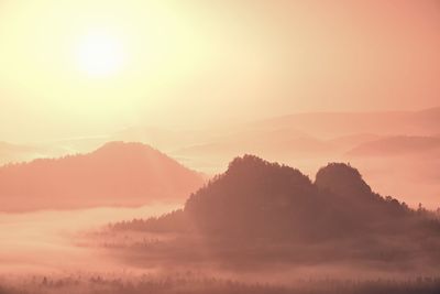 Scenic view of mountains against sky during sunset