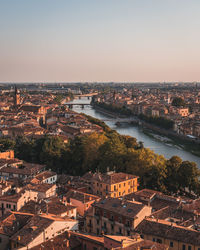 River amidst buildings in city against clear sky