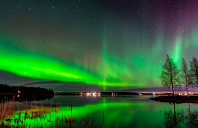 Scenic view of lake against sky at night