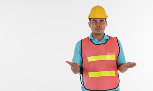 Portrait of smiling man standing against white background