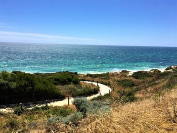 Scenic view of sea against clear blue sky