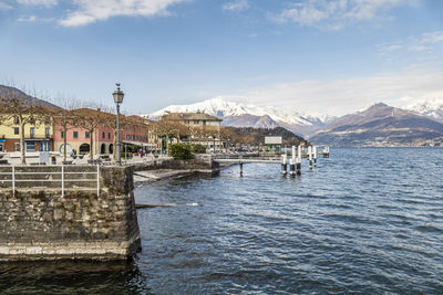 The lakeside promenade of colico with the snow-capped alps in the background