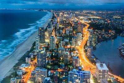 High angle view of illuminated buildings in city at night