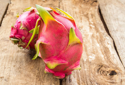 Close-up of pink rose on wood