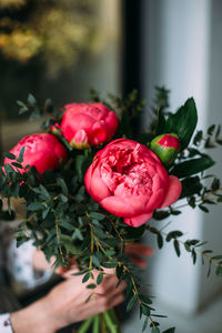 Florist woman collects a bouquet of pink peony roses. small business concept,