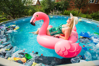 View of woman floating in swimming pool