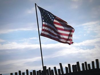 Low angle view of american flag against sky