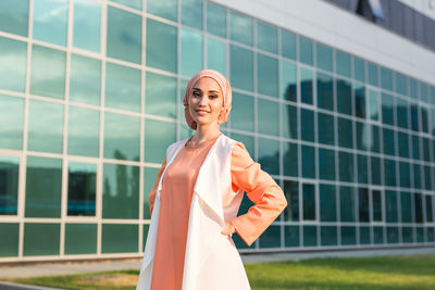 Portrait of smiling young woman standing outdoors