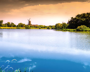 Scenic view of lake against sky during sunset