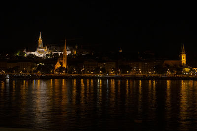 Illuminated city at waterfront