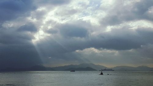 Scenic view of mountains against cloudy sky