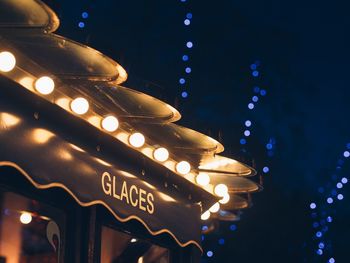 Low angle view of illuminated lights at night
