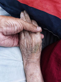 Cropped hand of man touching abdomen