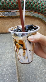 Close-up of hand pouring drink in glass