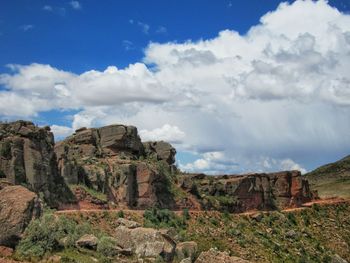 Rock formations on landscape against sky