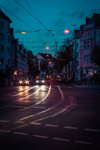 View of city street and buildings at night