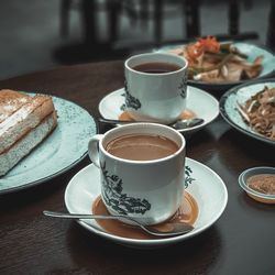 Coffee and cups on table