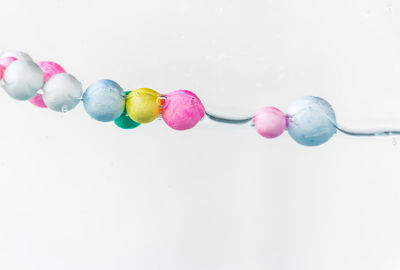 Close-up of multi colored candies against white background