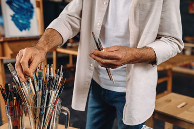 Midsection of man working on table