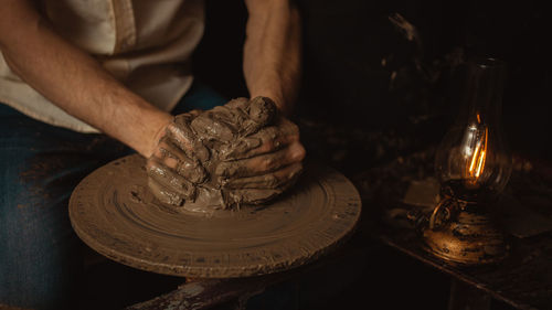 Man makes plate in pottery workshop, clay product, authentic atmosphere, background, footage. 