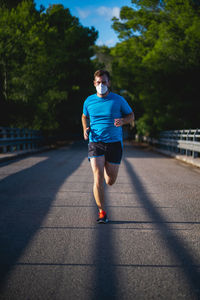 Full length of boy running on road