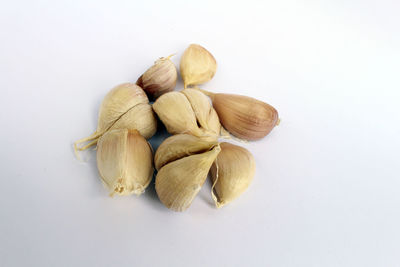 High angle view of garlic against white background