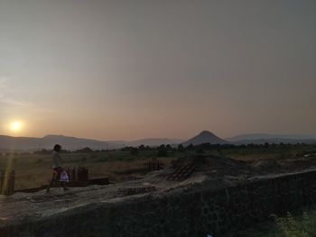 Scenic view of field against sky during sunset