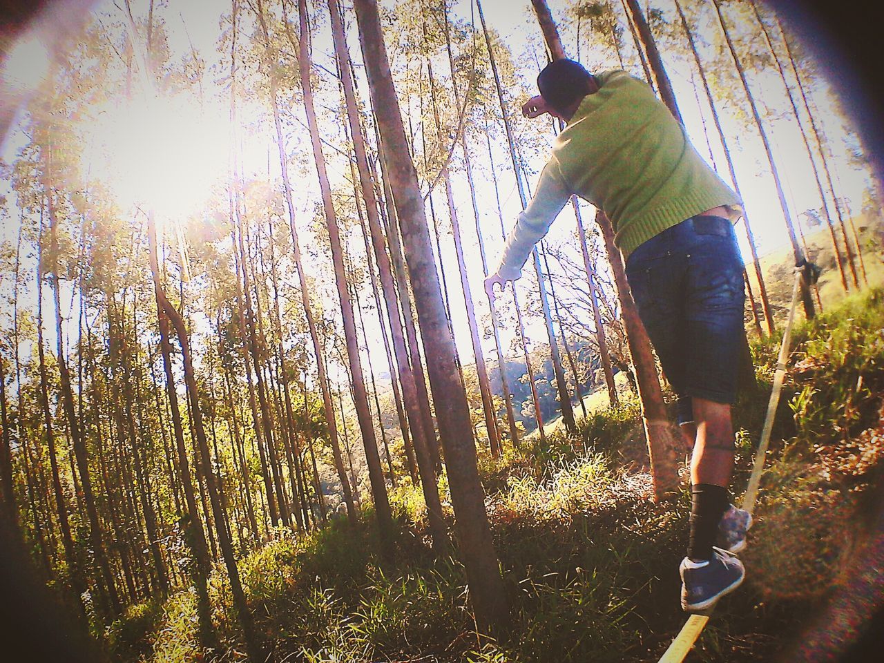 WOMAN JUMPING ON TREE TRUNK