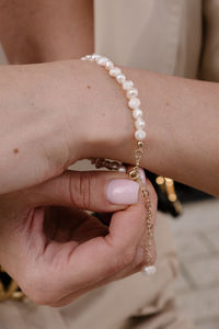 Close-up of woman locking the bracelet 