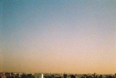 Cityscape against clear sky during sunset