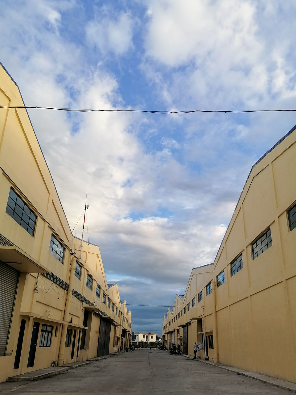 architecture, sky, cloud, built structure, building exterior, urban area, building, transportation, road, city, nature, facade, no people, business, outdoors, industry, street, diminishing perspective, day