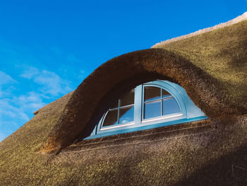 Low angle view of built structure against blue sky