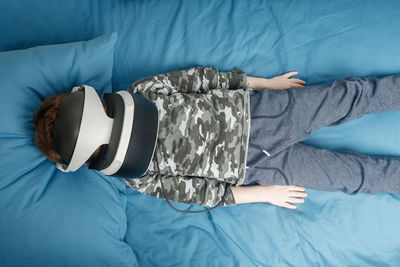 High angle view of woman lying on bed