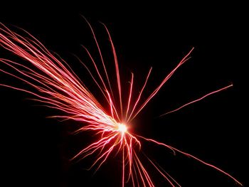 Low angle view of firework display at night