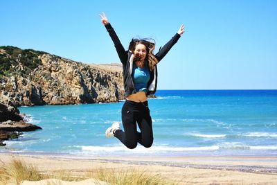 Full length of woman standing on beach