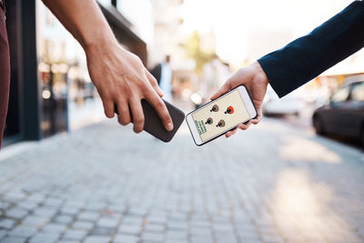 Low section of man using mobile phone