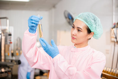 Portrait of young woman holding dentures