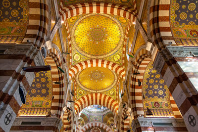 Low angle view of ornate ceiling in temple